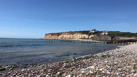 view from a stoney beach looking a coastal town on the south coast of england