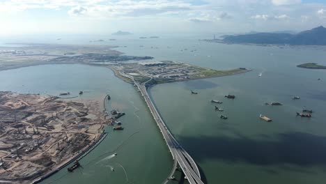 commercial airplane taking off at hong kong zhuhai macau bridge on a beautiful day, wide angle aerial view