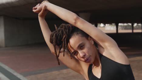 Front-view-of-young-African-American-woman-exercising-in-the-city-4k