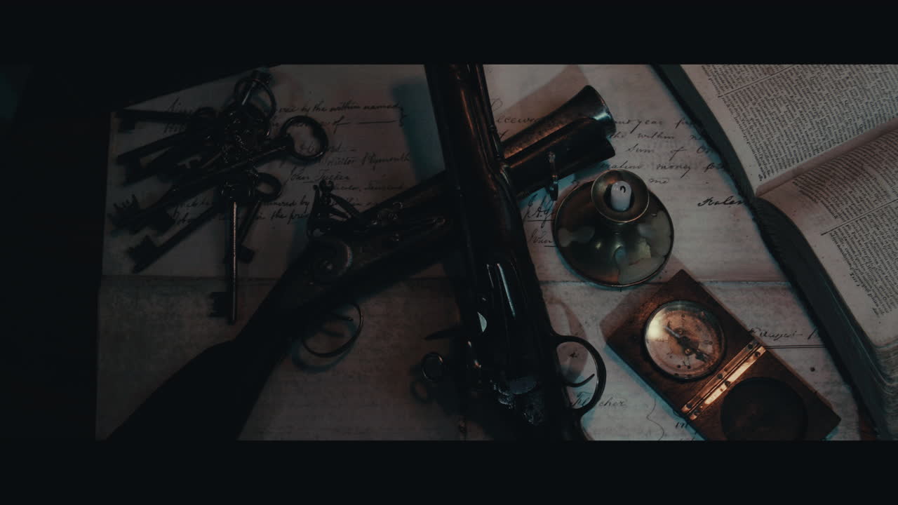 Two pistols and compass on the table filled with documents and maps inside the sailing ship cabin