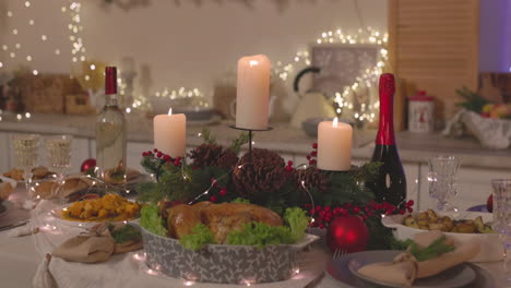 traditional delicious food and burning candles on christmas dinner table 2