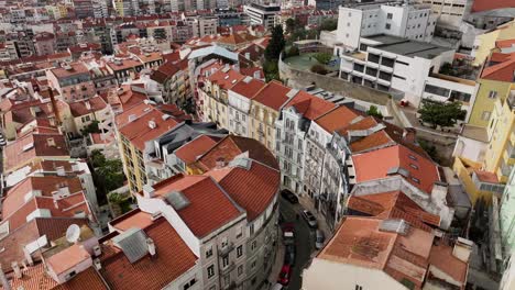 drone shooting and turning to the left over a curvy street in lisbon