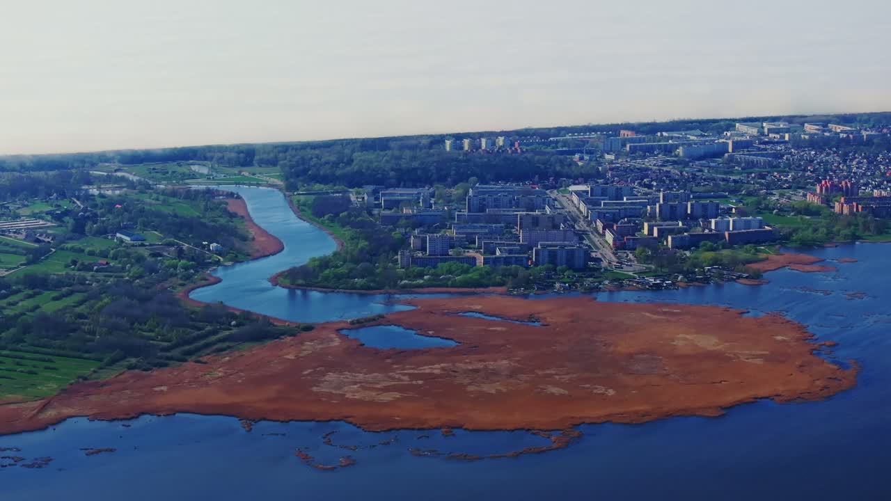 High aerial view, Liepaja Latvia showing mix of city buildings, coastal marshes
