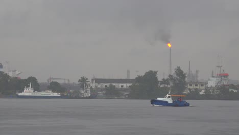 Harbor-ferry-boats-pass-in-Havana-harbor-Cuba-with-an-industrial-scene-as-a-backdrop