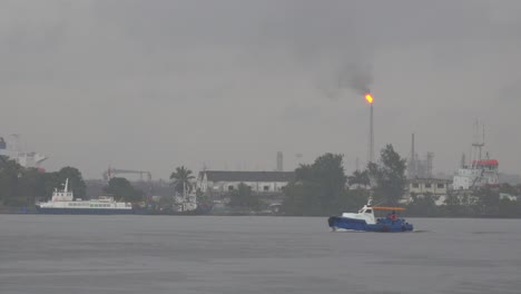 harbor ferry boats pass in havana harbor cuba with an industrial scene as a backdrop
