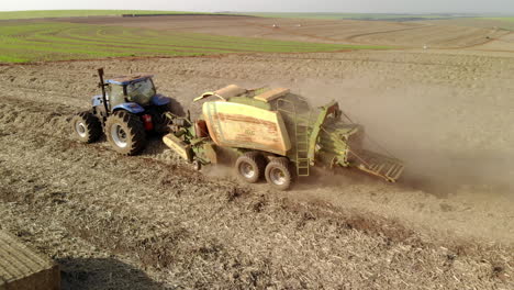 sugar cane straw baler working in the field after harvesting the crop