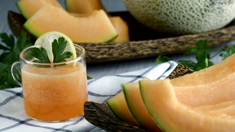 whole and sliced of japanese melons,honey melon or cantaloupe (cucumis melo) glass of melon smoothie healthcare concept.