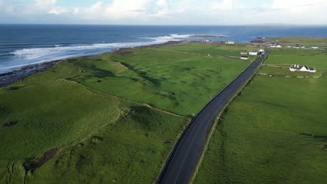 slow aerial establishing shot of houses with a view over the doolin cliffs