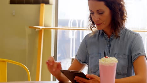 Female-executive-using-digital-tablet-at-table-4k