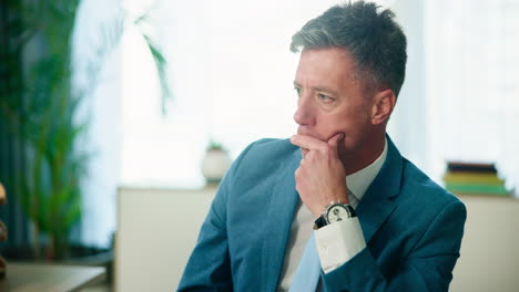 businessman in a suit thinking in an office