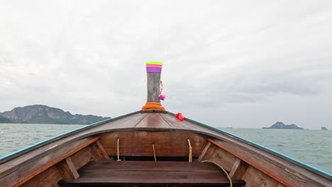 boat travels through ocean towards distant islands