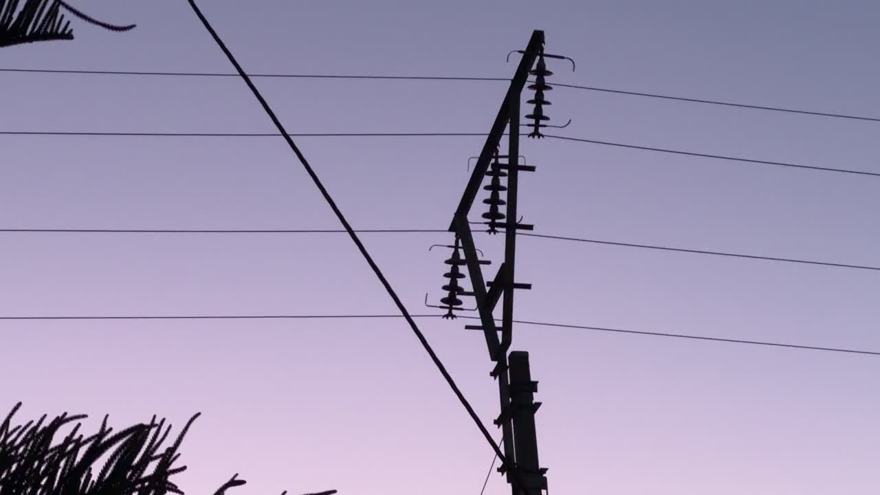 A railway line Pylon on a railway track in Cape Town, South Africa at sunset
