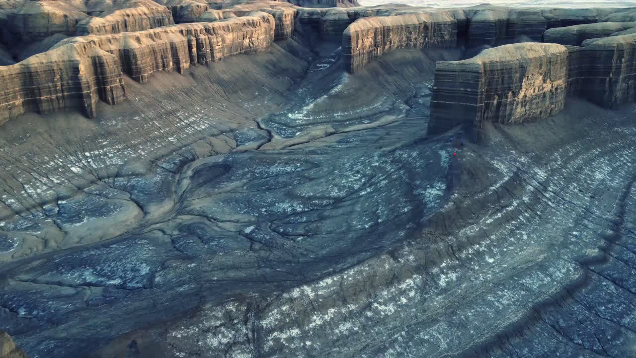 Unrecognizable hiker standing on rocky terrain in volcanic valley during trip