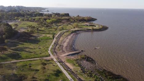 a tilting aerial shot of a public park at the coastal area in buenos aires, argentina