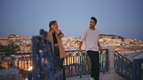 couple talking first date at night cityscape. happy diverse pair enjoy evening