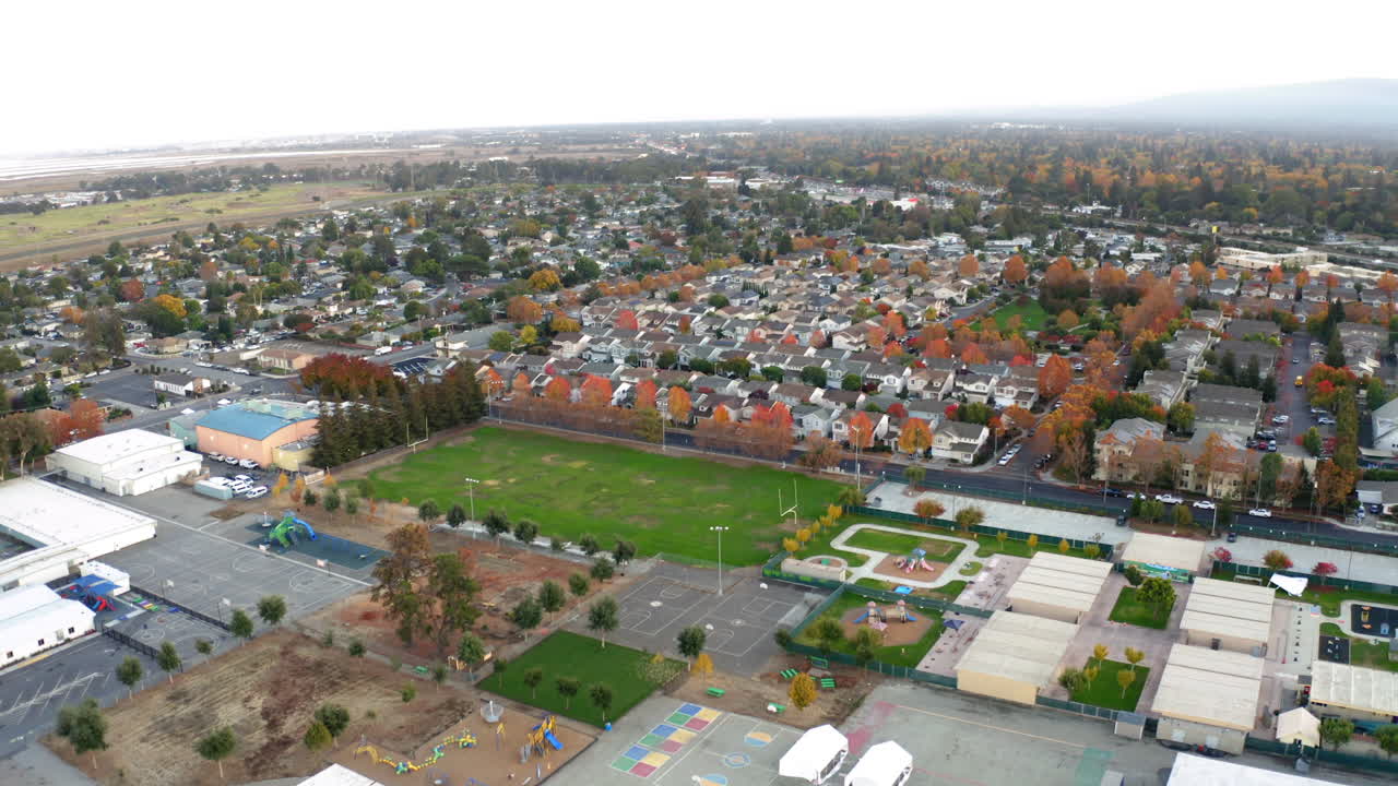 Aerial View of a Suburban School Campus and Residential Neighborhood in Autumn