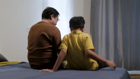 asian man and boy in the bedroom