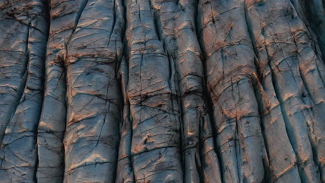 close up tilting aerial of glacier ice revealing huge glacial landscape