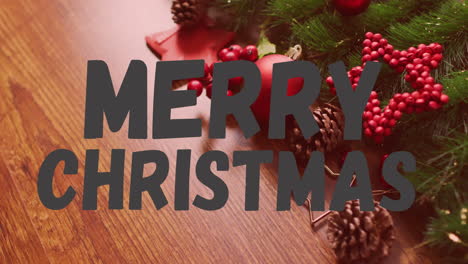merry christmas text animation over festive decorations with pinecones and berries