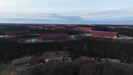 large-red-bourbon-barrel-rick-houses-in-Frankfort-Kentucky-AERIAL-TRUCKING-PAN