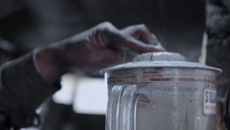 Close-Up-Of-A-Hand-Holding-Lid-Of-A-Blender-Making-Smoothies