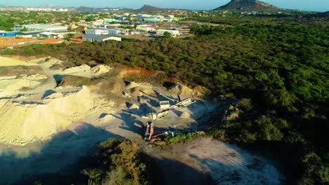 drone orbit around linear overpile portal reclaiming heavy machinery in industrial zone