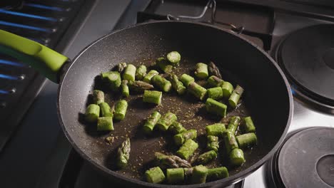 chopped asparagus cooking and stirred in a skillet