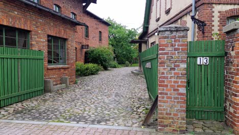 old-scary-yard-stone-pavement-red-brick-building-no-13-aerial-dolly-tilt