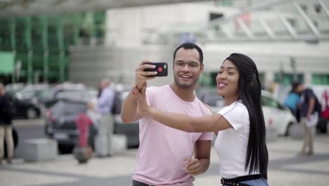 Smiling-friends-gesturing-while-posing-for-self-portrait