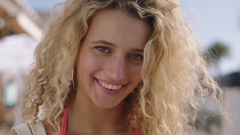 close-up-portrait-of-beautiful-blonde-woman-running-hand-through-hair-smiling-confident-enjoying-relaxed-sunny-day