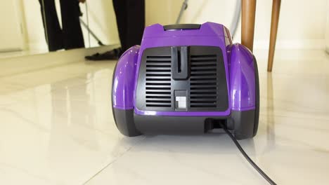 purple vacuum cleaner on tile floor