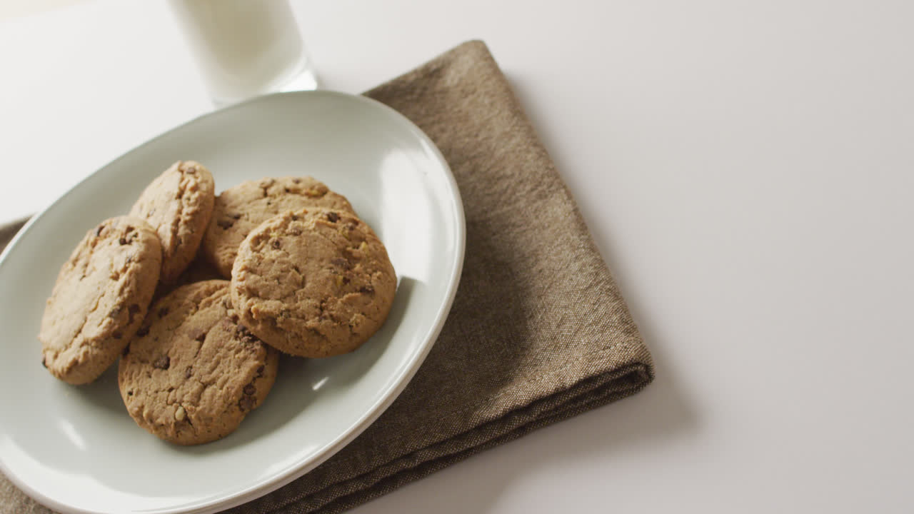 Video of biscuits with chocolate and milk on white background