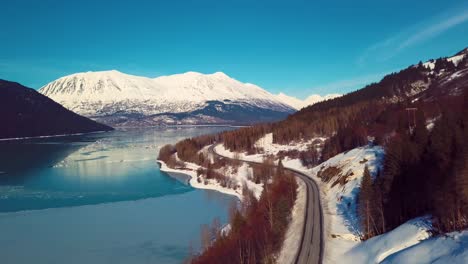 4K-Drone-Video-of-Snow-Covered-Lakeside-Mountains-in-Alaska-During-Winter