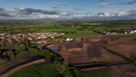 Aerial-orbiting-shot-showing-the-ground-development-for-a-housing-estate-with-diggers