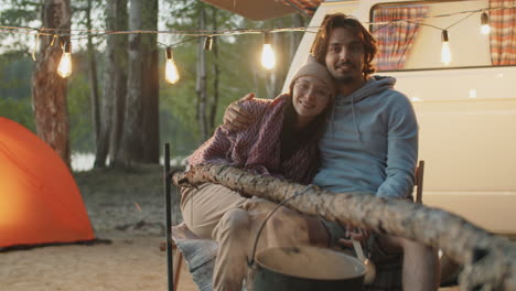 Portrait-of-Young-Beautiful-Couple-at-Campsite-in-Evening