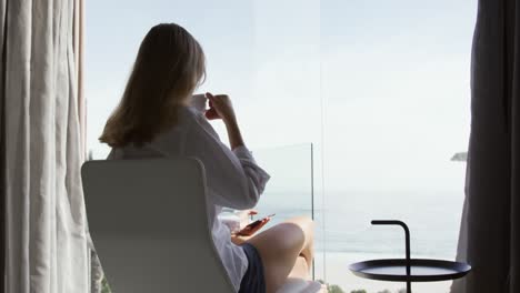 Caucasian-woman-drinking-coffee-in-hotel