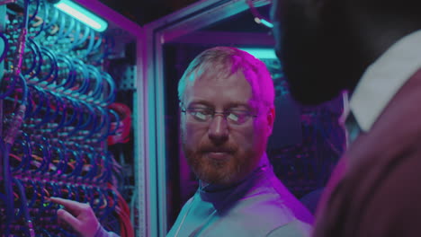 it engineers working and maintaining servers in a neon-lit data center