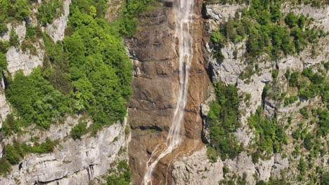 a captivating view of seerenbachfälle, switzerland, showcases multiple waterfalls cascading down vast, green-clad cliffs.