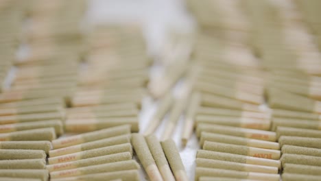Close-up-shot-of-stacked-pre-roll-Keif-infused-joints,-Tracking-out-motion