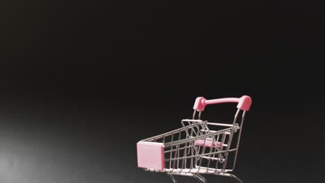 carrito de compras vacío en un fondo negro iluminado sin costuras con espacio de copia