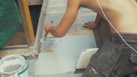 Painting-deck-planking-of-wooden-boat-with-protective-exterior-paint