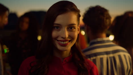 Charming-woman-looking-camera-night-party.-Portrait-of-model-smiling-outdoors