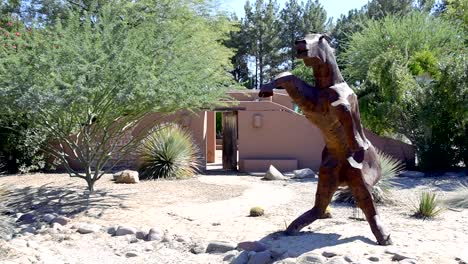 sculpture of a large metal horse on hind legs straight on view pan left