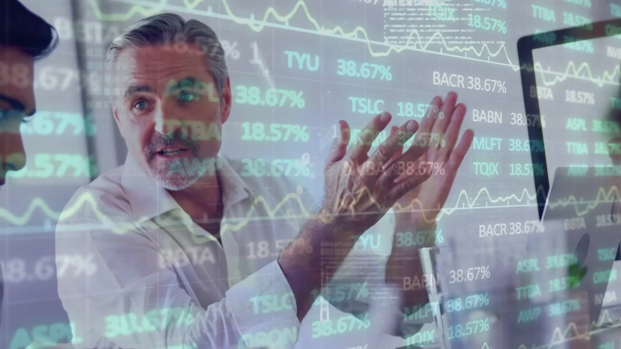 Diverse coworkers at meeting table analyzing market data, notepad, coffee cup, senior man gesturing