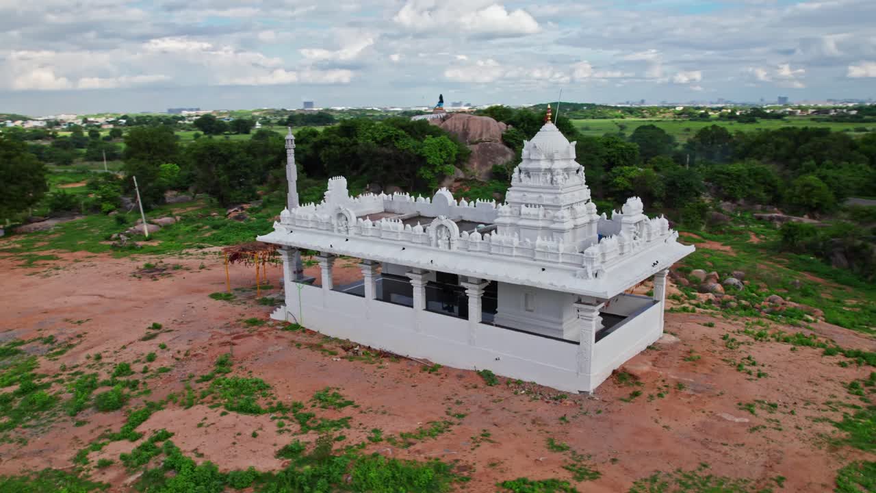Temple back side with greenery, sky and clouds at day time, semi orbit, drone shot, 4k.