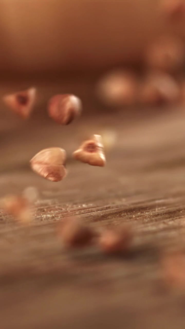 Buckwheat Grains Falling and Bouncing on a Wooden Surface in Slow Motion