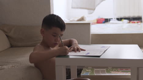 little boy practice how to write during summer holiday