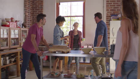 Five-friends-stand-having-coffee-in-kitchen,-shot-on-R3D