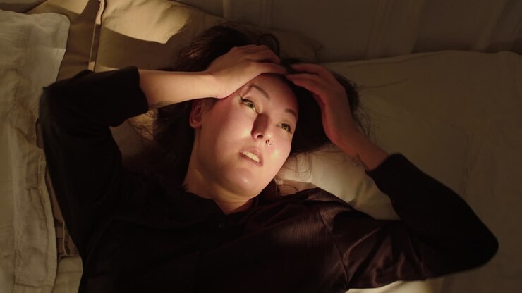 Woman covering his head with a pillow