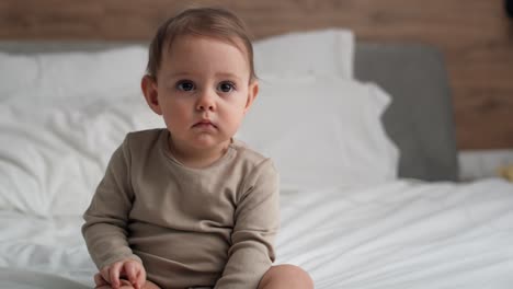 video of caucasian little babysitting in the bed.